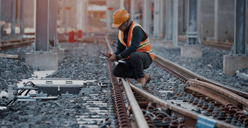 railway worker inspecting tracks