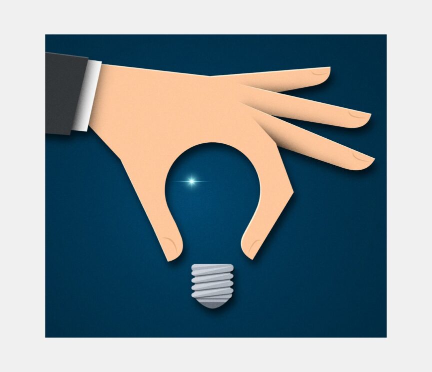 A hand holds a light bulb with only a slight glimmer or light